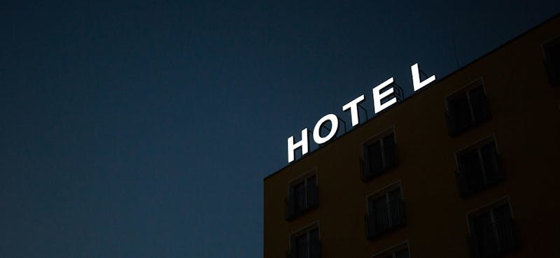 A neon hotel sign shining in the night in Friedrichshain, Berlin, Germany.