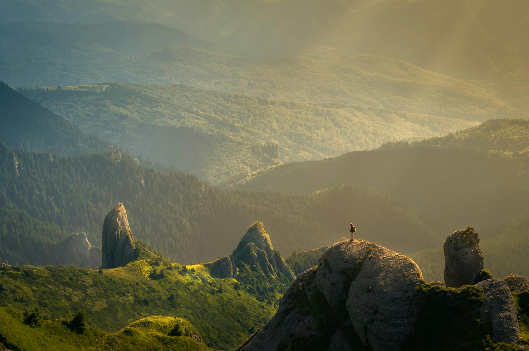 Man hiking alone in unspoilt wilderness near Ciucaș Peak, Romania.