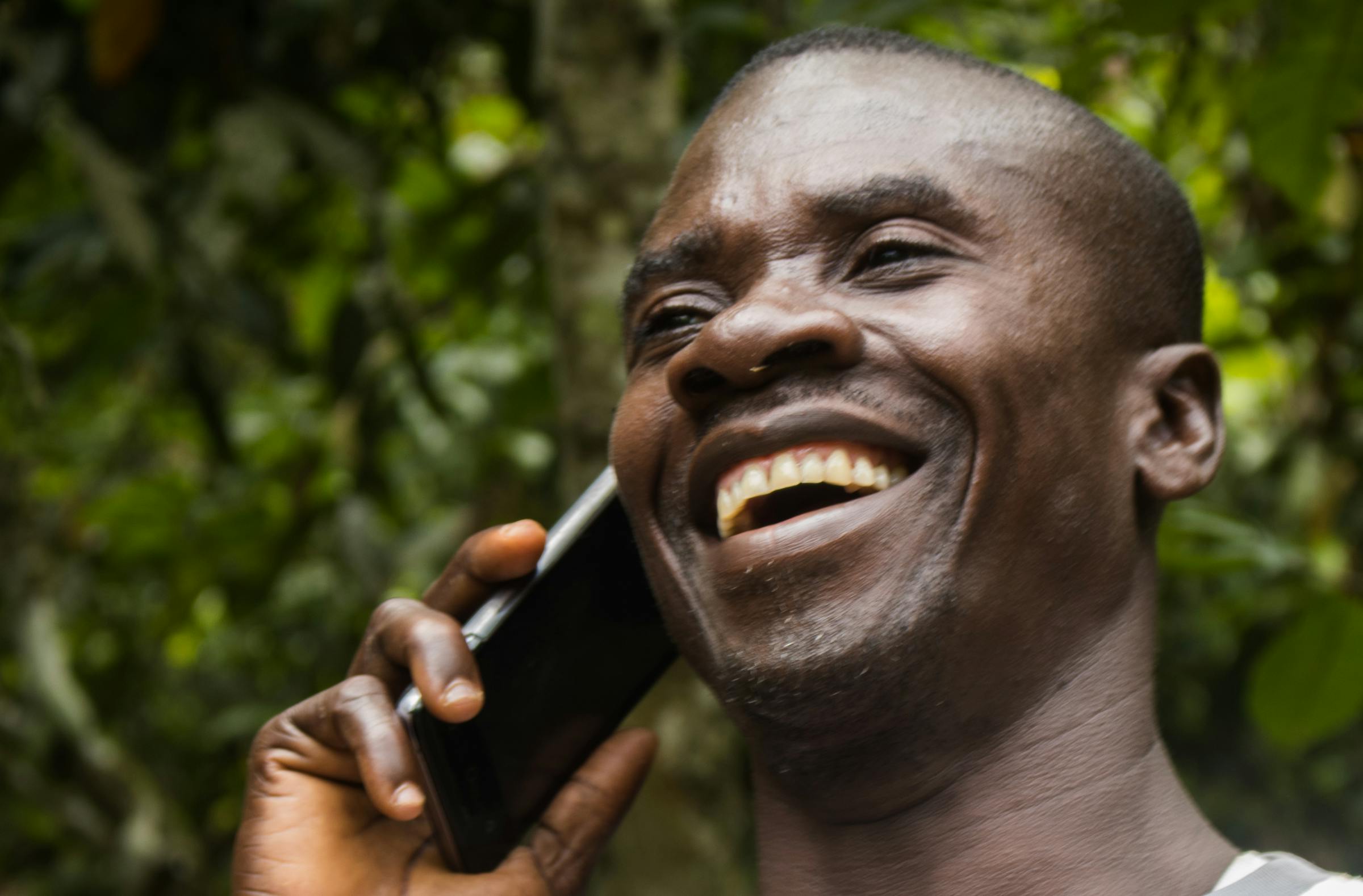 Ghanaian cocoa farmer on phone'